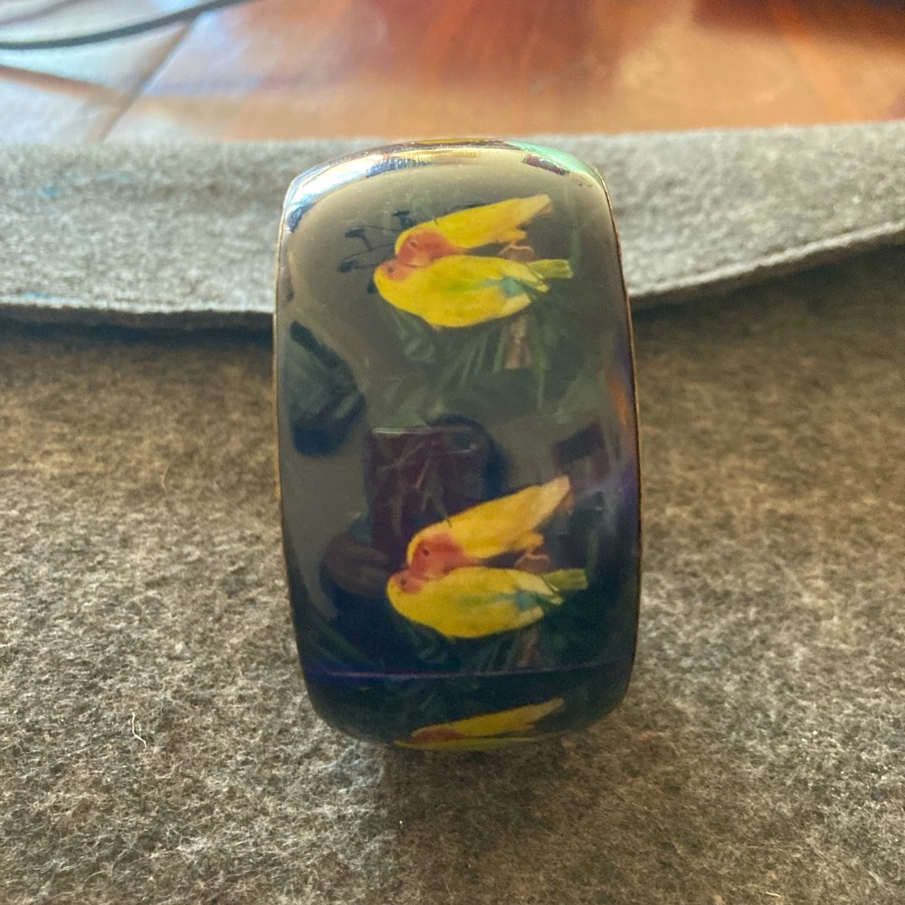 A dark green bracelet with kissing birds.